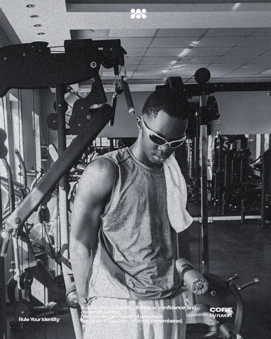 Man in white Ruvori sunglasses and a gray sleeveless top, a white towel over his shoulder, in a gym, in black and white.